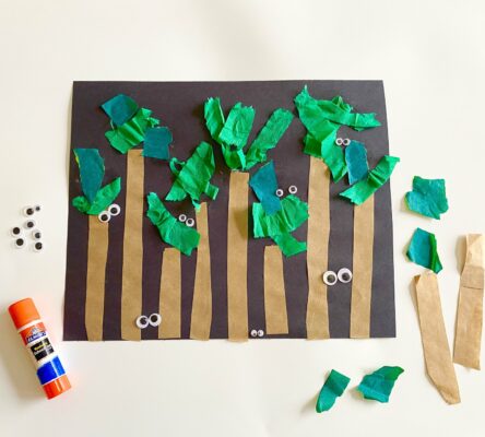 Paper craft of a nighttime forest with friendly eyes all around.