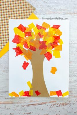 A fall tree craft made by tearing colored tissue paper for the leaves and gluing them to the tree.