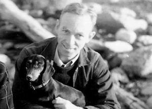 Author EB White, holding a dachshund