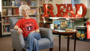 Kate DiCamillo sitting in front of giant red READ letters